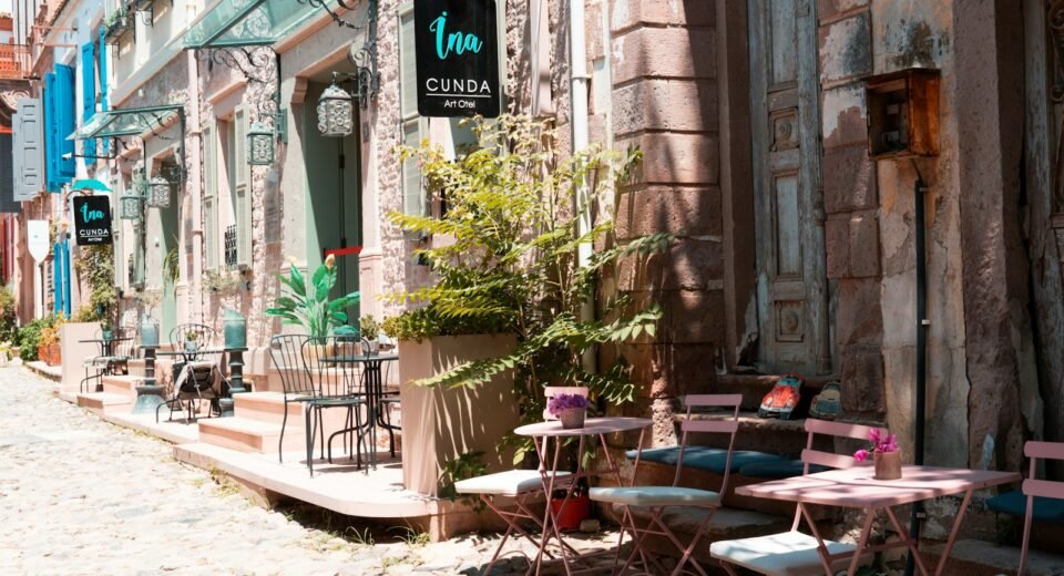 a row of tables and chairs outside of a building